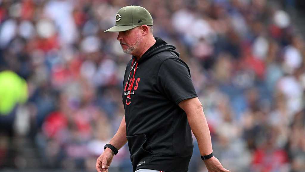 Photo: wlwt.com CLEVELAND, OHIO - MAY 16: Pitching coach Derek Johnson #36 of the Cincinnati Reds walks off the field during the second