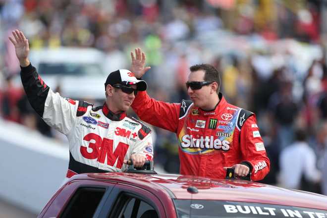 Greg Biffle, driver of the #16 3M Ford, and Kyle Busch, driver of the #18 Skittles Toyota, during the NASCAR Sprint Cup Series The Profit On CNBC 500 at Phoenix International Raceway on March 2, 2014, in Avondale, Arizona.