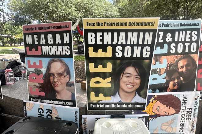 Supporters of protesters convicted over a shooting outside a Texas immigration detention center display signs in support of the defendants outside a federal courthouse in Fort Worth, Texas on Tuesday, June 23, 2026. (AP Photo/Kendria LaFleur)