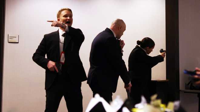 Secret Service agents respond during the White House Correspondents Dinner, Saturday, April 25, 2026, in Washington.
