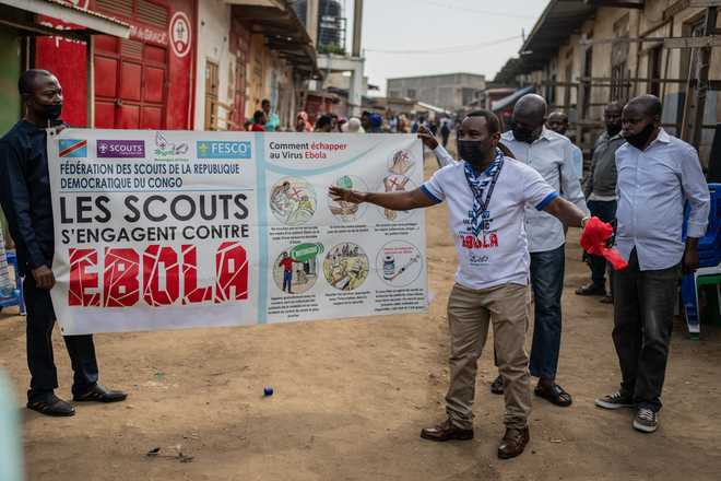 Members of the Congo Scouts movement carry an Ebola awareness banner along a street during a public sensitisation campaign amid the Ebola outbreak in Bunia, Congo, Saturday, May 23, 2026.