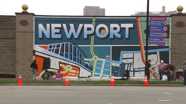 Newport High School students help paint new murals on city's floodwall