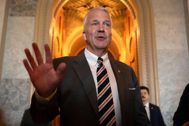 FILE - Sen. Dan Sullivan, R-Alaska, speaks to reporters at the Capitol in Washington, June 30, 2025.