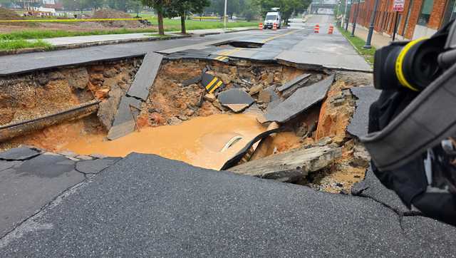 Officials: Woman uninjured after car fell into massive sinkhole early Saturday morning