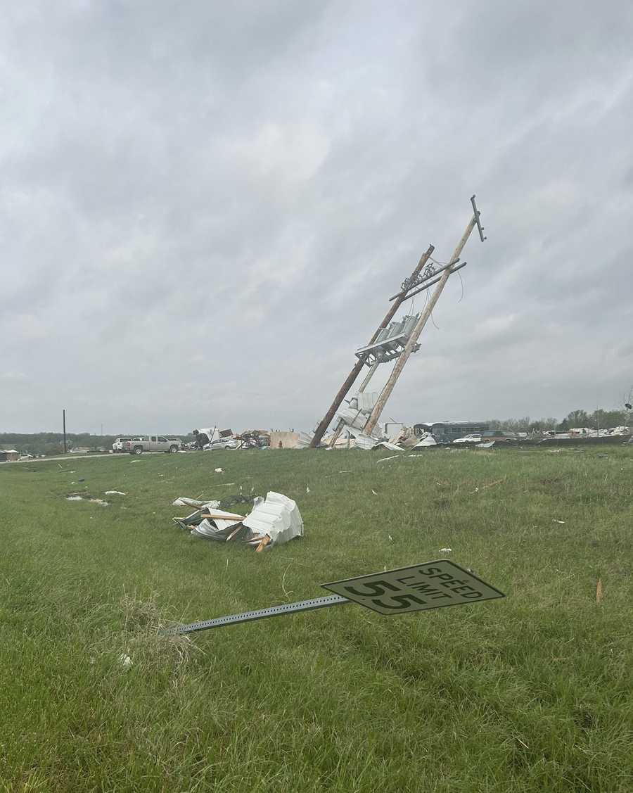 Power lines are down and wreckage is seen in Hillsdale, Kansas, after a tornado-warned storm on April 13, 2026.