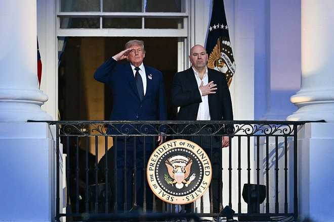 US President Donald Trump and UFC CEO Dana White stand for the national anthem during the "UFC Freedom 250" mixed martial arts event on the South Lawn of the White House in Washington, DC, June 14, 2026. (Photo by Kent NISHIMURA / AFP via Getty Images)