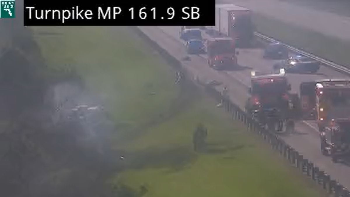 Construction truck crashes through guardrail, bursts into flames on Florida's Turnpike in St. Lucie County
