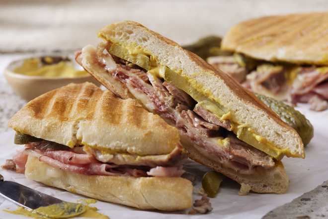 Classic Grilled Cuban Sandwich with Roast Pork, Honey Ham, Swiss Cheese, Dill Pickles and Mustard