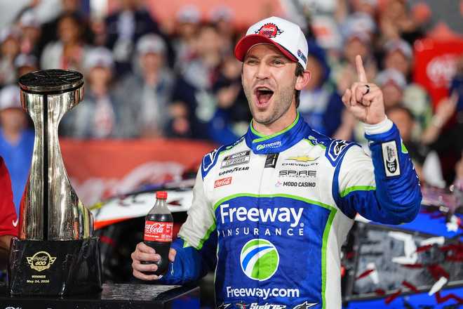 Daniel Suarez celebrates in Victory Lane after winning a NASCAR Cup Series auto race, Sunday, May 24, 2026, in Charlotte, N.C. (AP Photo/Matt Kelley)
