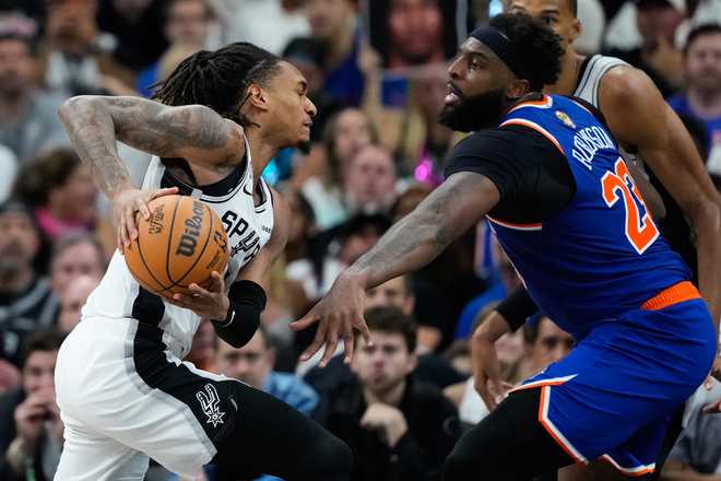 San Antonio Spurs guard Devin Vassell drives as New York Knicks center Mitchell Robinson (23) defends during the second half of Game 5 of the NBA Finals basketball series, Saturday, June 13, 2026, in San Antonio.