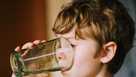 Young boy drinking water