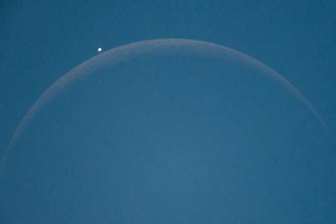 Lunar occultation of Venus planet is seen through a telescope from L'Aquila, Italy, on September 19th, 2025. Venus disappeared behind the moon for about one hour during the afternoon. The astronomical show was visible through a telescope, a binocular or a photo camera associated to telephoto lens. (Photo by Lorenzo Di Cola/NurPhoto via Getty Images)