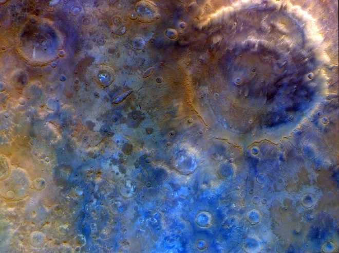 An enhanced color view shows Mars' large double-ring Huygens Crater and the southern highlands.