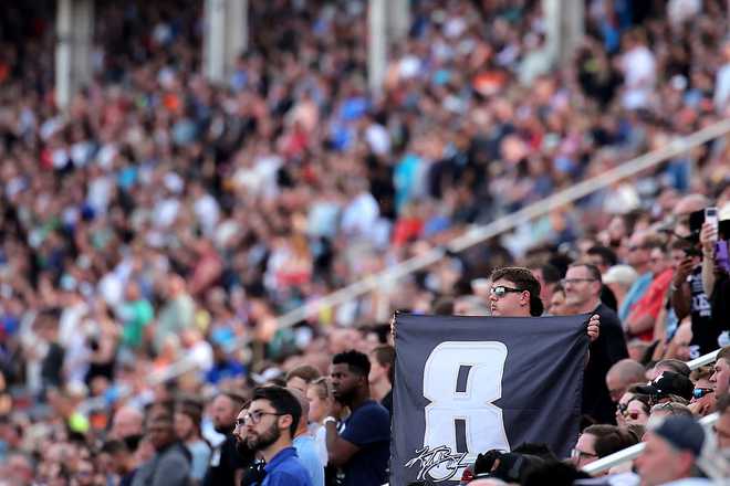 A NASCAR fan displays a #8 flag during the remembrance ceremony for Kyle Busch, who passed away suddenly at the age of 41, from the grandstands prior to the NASCAR Cup Series Coca-Cola 600 at Charlotte Motor Speedway on May 24, 2026, in Concord, North Carolina.