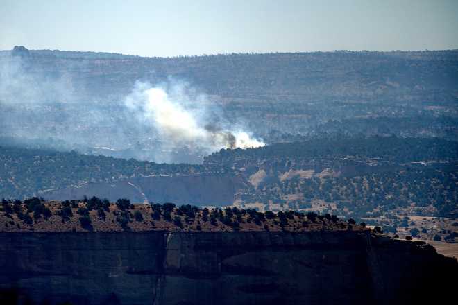 Smoke rises from the Snyder Fire burning near Thompson Springs, Utah, on Sunday, June 28, 2026.