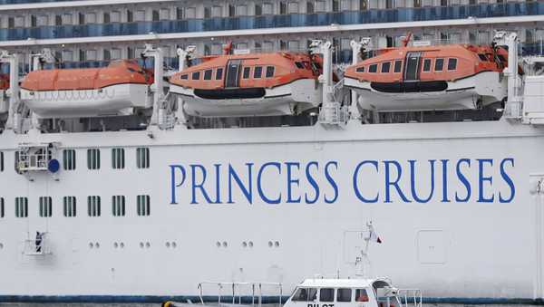 A pilot boat passes near the Regal Princess cruise ship at Port Everglades in Fort Lauderdale, Fla., Tuesday, March 10, 2020. The Regal Princess and another cruise ship Caribbean Princess that left from Fort Lauderdale have been issued "no sail" orders by the U.S. Centers for Disease Control and Prevention after crew members who had possibly been exposed on a California ship were tested. The Regal Princess has since docked at the port, and passengers have been able to leave the ship. (AP Photo/Wilfredo Lee)