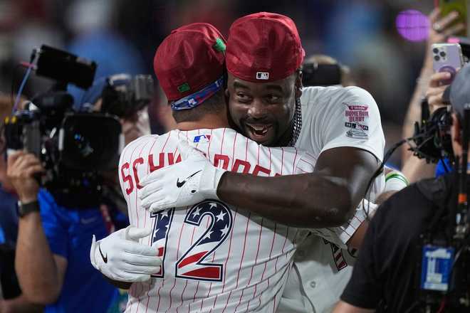 St. Louis Cardinals' Jordan Walker embraces Philadelphia Phillies' Kyle Schwarber after Walker won the MLB baseball All-Star Home Run Derby, Monday, July 13, 2026, in Philadelphia.