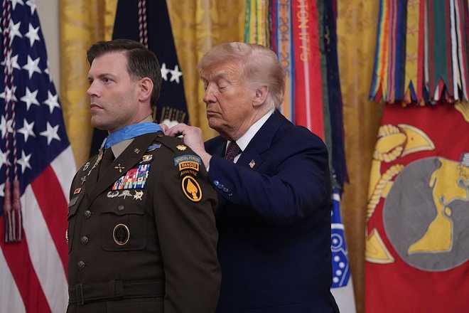 US President Donald Trump bestows the Medal of Honor to retired US Army Major Nicholas Dockery in the East Room of the White House in Washington, DC on June 18, 2026. (Photo by Ken Cedeno / AFP via Getty Images)