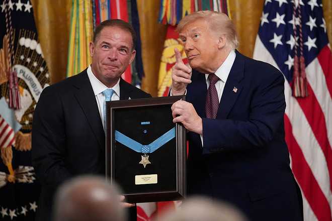 WASHINGTON, DC - JUNE 18: U.S. President Donald Trump presents the Medal of Honor to the family of Colonel John W. Ripley, U.S. Marine Corps (Posthumous), during a Medal of Honor Ceremony in the East Room of the White House on June 18, 2026 in Washington, DC.  Major James Capers Jr., an 88-year-old Vietnam veteran, saved multiple lives of Marines under his command during a 1967 battle at Phu Loc, all while suffering from several gunshot wounds. President Trump will also award the Medal of Honor to Colonel John W. Ripley, U.S. Marine Corps (Posthumous), and Major Nicholas Dockery, U.S. Army (Retired). (Photo by Andrew Harnik/Getty Images)