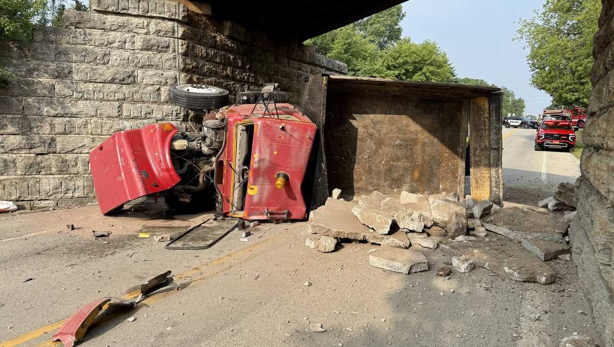 Dump truck rolls after hitting railroad bridge in Port Washington