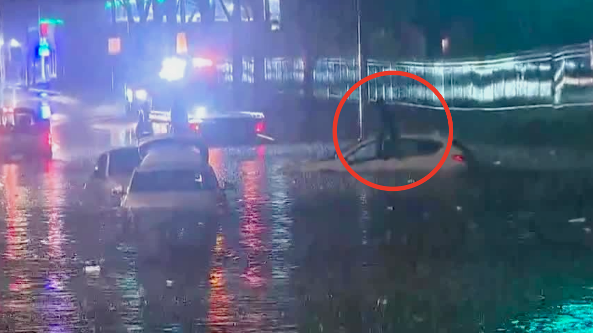 Driver hangs out of car window to ask for help in Milwaukee flood