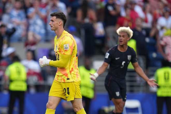 United States' Matt Freese, left, and Antonee Robinson react after Belgium scored their third goal during the World Cup round of 16 soccer match between the United States and Belgium in Seattle, Monday, July 6, 2026.