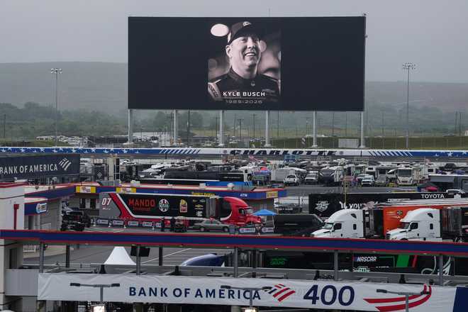An in memoriam photo of former driver Kyle Busch is displayed on the video board of the backstretch at Charlotte Motor Speedway, Friday, May 22, 2026, in Charlotte, N.C.
