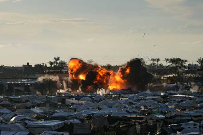 Smoke and flames rise following an Israeli military strike on a target next to a tent camp in Deir al-Balah, central Gaza Strip, Wednesday, March, 25, 2026