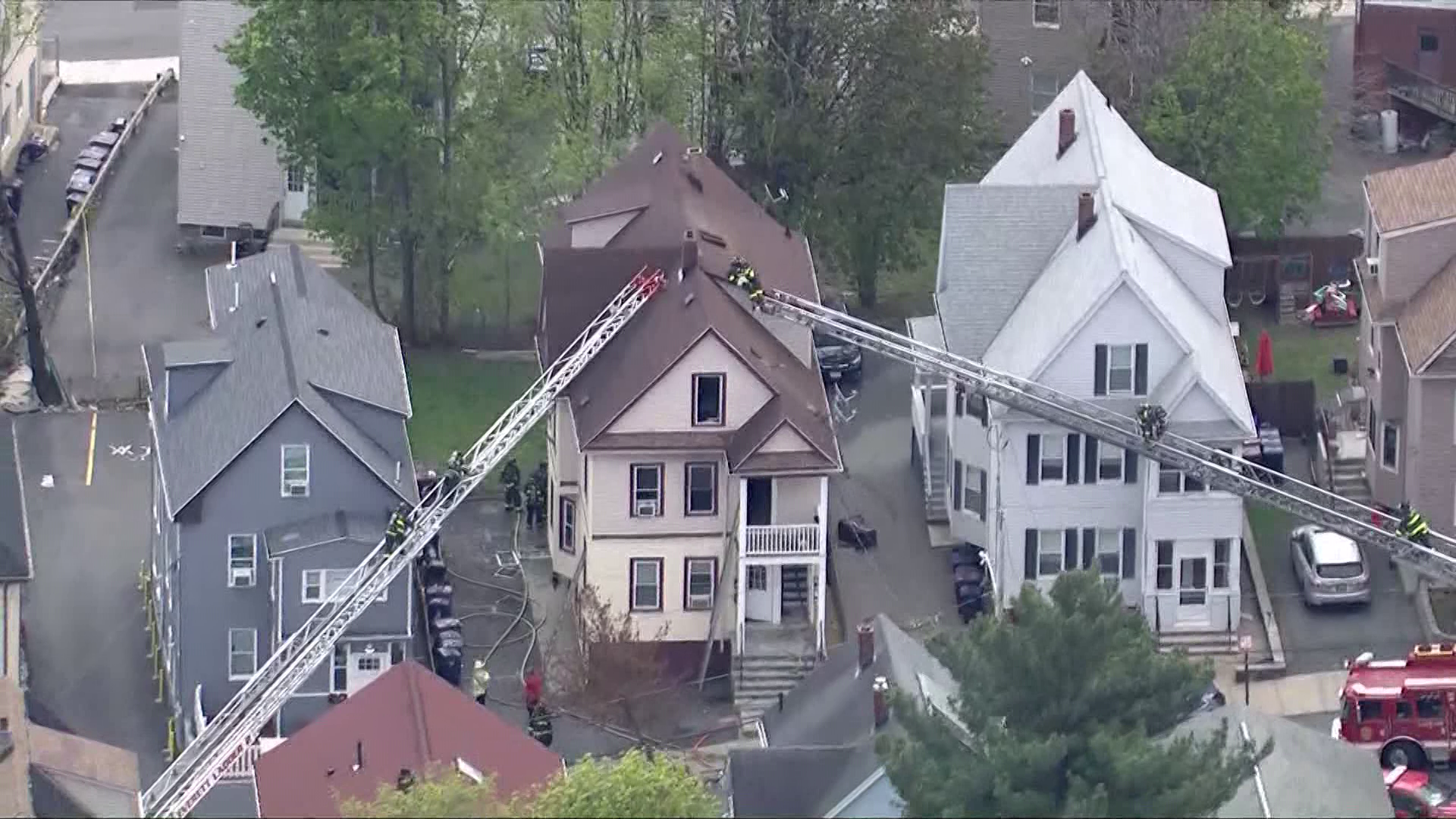 Woman jumps from window after Mass. home catches fire