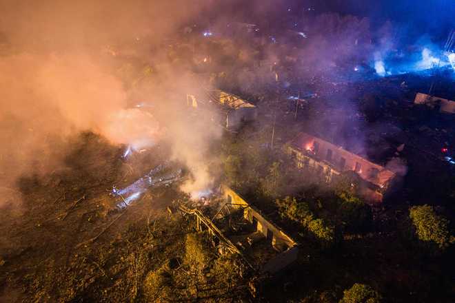 In this photo released by Xinhua News Agency, this aerial drone photo taken in the early hours of May 5, 2026, rescuers work on site after an explosion at a fireworks plant in Guandu Town of Liuyang, central China's Hunan Province.