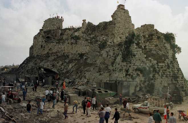 FILE -Villagers inspect the damage to Beaufort Castle, 10 kilometers (6 miles) northwest of the southern market town of Nabatiyeh, Lebanon, Wednesday, May 24, 2000. (AP Photo/Ahmed Mantash, File)