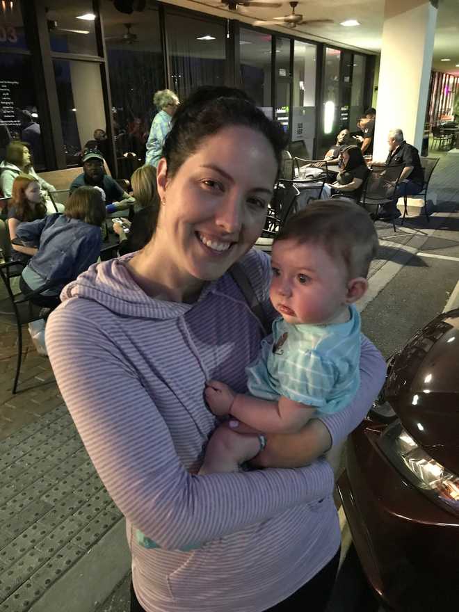 This image provided by Chris Carberg shows Jenna Carberg holding Elsie on April 30, 2017, in Winter Park, Fla. (Chris Carberg via AP)