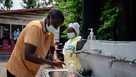 A visitor washes his hands before entering Kyeshero Hospital at a checkpoint for hand washing and temperature screening for all visitors and patients entering Kyeshero Hospital, as part of Ebola prevention measures in Goma on May 18, 2026. 
