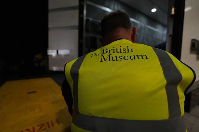 A British Museum worker unloads objects out of a truck at the British Museum in London, Friday, July 10, 2026.