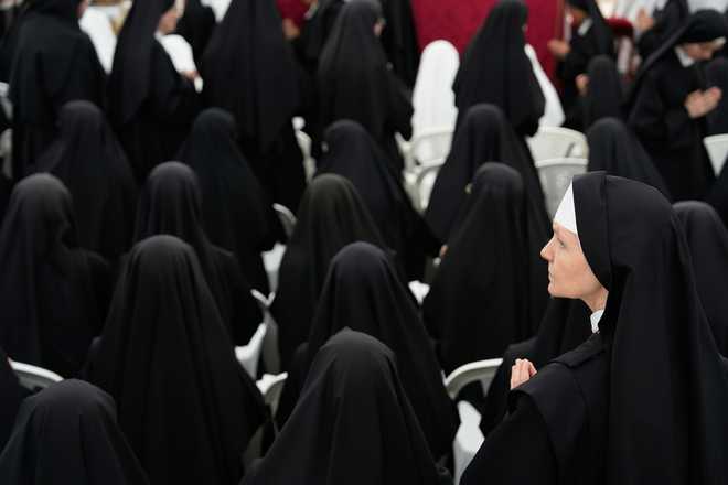 Nuns attend a consecration ceremony for four new bishops in a tent set up outside the Society of St. Pius X seminary, in Econe, Switzerland, Wednesday, July 1, 2026. (AP Photo/Baz Ratner)