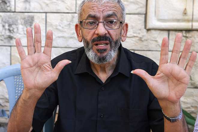 Palestinian journalist Ali al-Samoudi speaks to the press at his home in the northern city of Jenin, in the Israeli-occupied Palestinian West Bank on May 1, 2026. Sixty-year-old Al-Samoudi was released following one-year in detention in the Israeli Naqab Prison, located in southern Israel. He was released and checked at the Jenin Hospital where he said, "I was 120 kilogrammes; my weight now is barely 60 kilogrammes". Israel has jailed an increasing number of journalists since 2023, the year of Hamas's unprecedented October 7 attack on Israel, which responded with a devastating war in the Gaza Strip. (Photo by JAAFAR ASHTIYEH / AFP via Getty Images)