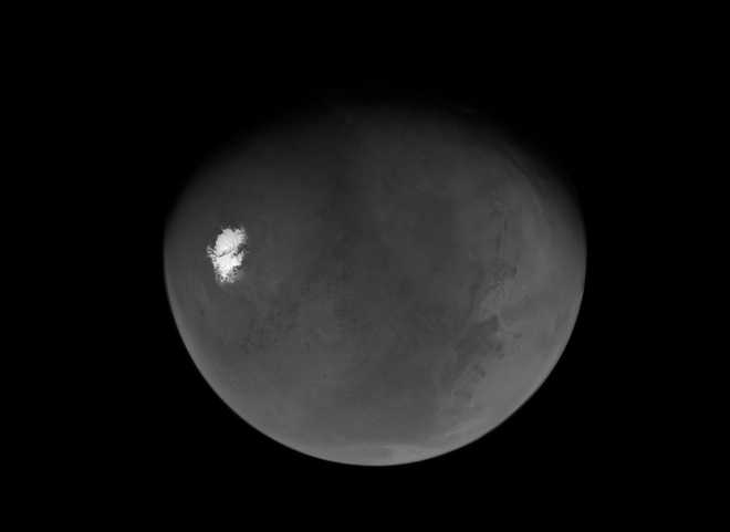 Psyche’s first view of a nearly full Mars extends from the south polar cap northward to the Valles Marineris canyon system.
