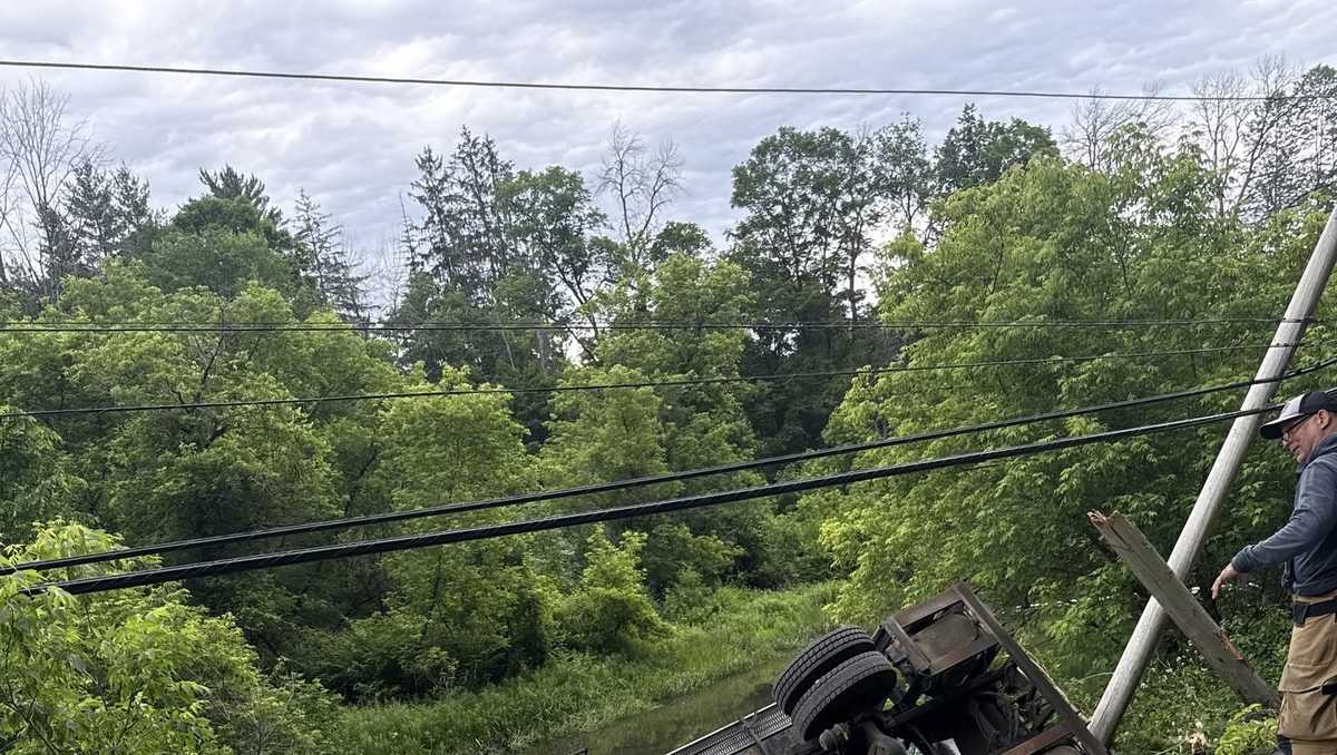 Truck rolls down embankment, leaks fuel into nearby river in Woodstock