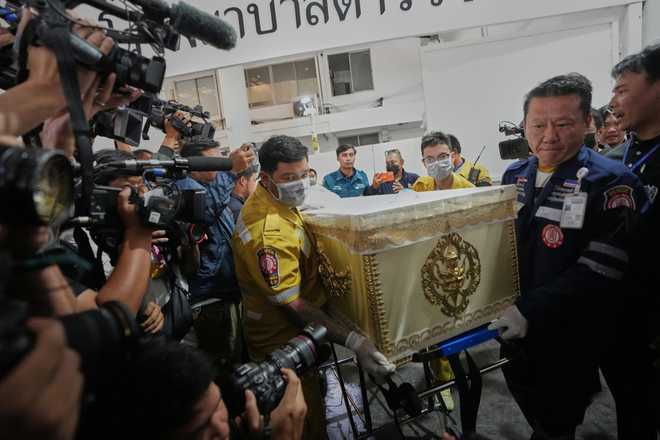 A coffin of a victim in a music bar fire is prepared to hand over to the relatives, unseen, at a police hospital in Bangkok, Thailand, Tuesday, July 14, 2026.