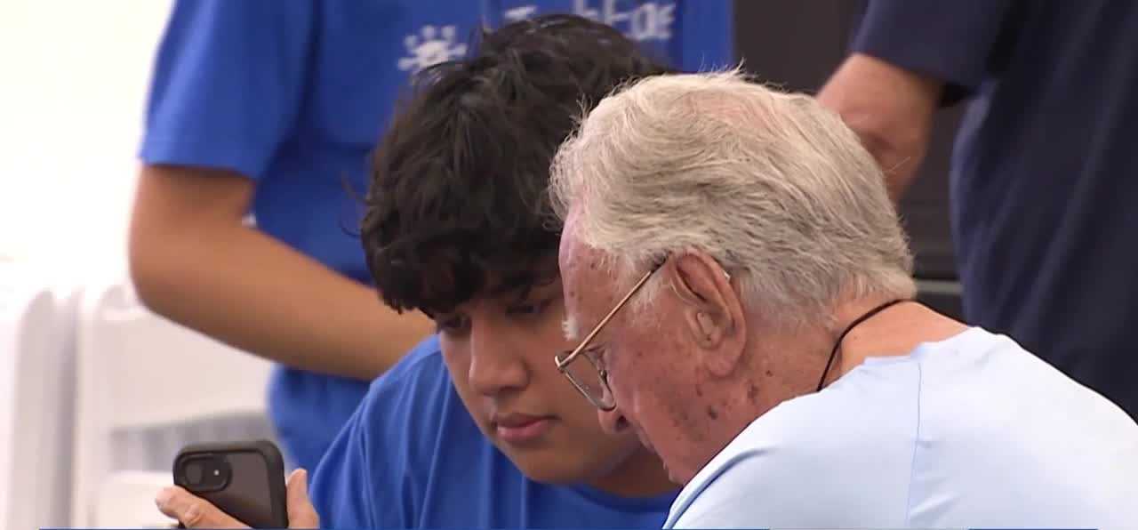 High school students help seniors with technology at Wellington Bay