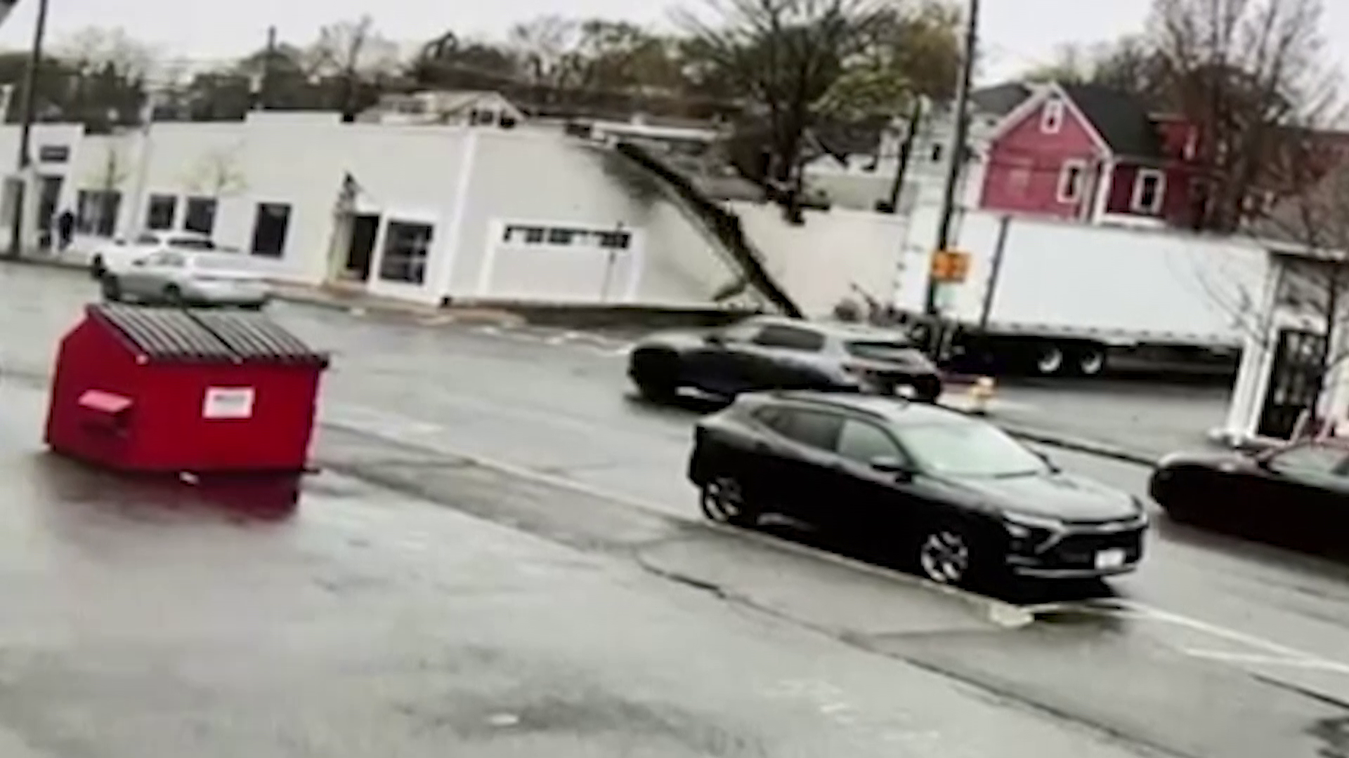Tractor-trailer takes down wires, part of facade from local music shop