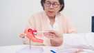 Elderly Woman patient consulting doctor with anatomy Uterus and Ovaries. Ovarian and Cervical cancer, Cervix disorder, Endometriosis, Hysterectomy, Uterine fibroids, Reproductive system and Pregnancy