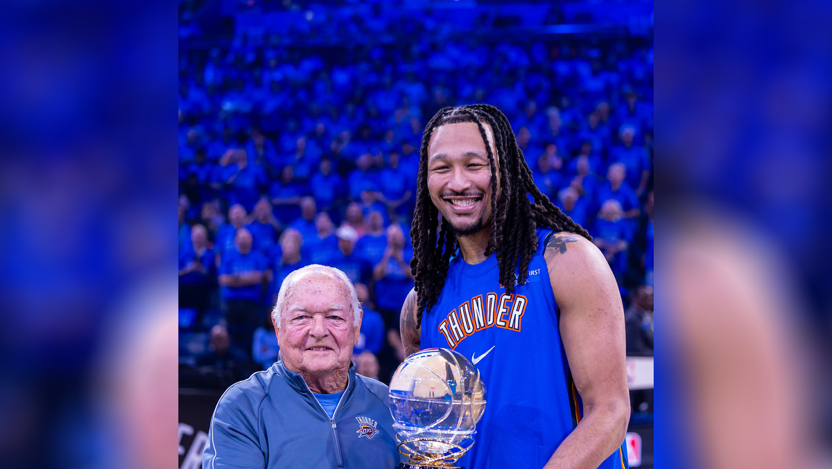Former OKC Mayor Ron Norick presents Northwest Division Champions trophy