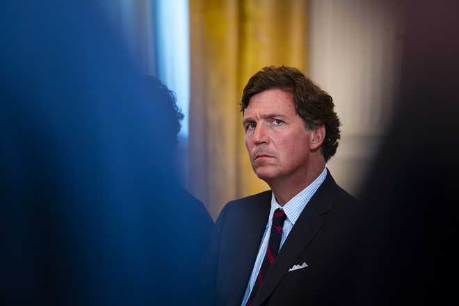 Tucker Carlson, former FOX News host and current host of The Tucker Carlson Show, attends a meeting with oil executives in the East Room of the White House on January 9, 2026, in Washington, DC.