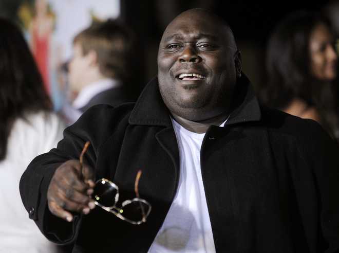 FILE - In this Monday, Oct. 5, 2009, file photo, Faizon Love, a cast member in "Couples Retreat," banters with photographers at the premiere of the film in Los Angeles. Love has been jailed on a misdemeanor assault charge in Ohio after an alleged altercation Tuesday, March 7, 2017, with a valet at John Glenn Columbus International Airport. (AP Photo/Chris Pizzello, File)