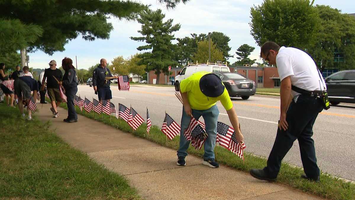Volunteers plant flags for 9/11 Path of Honor in Parkville
