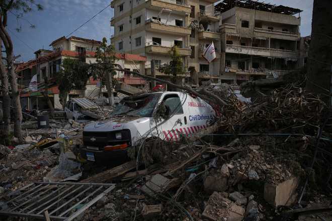 An ambulance belonging to Hezbollah's health unit lies amid the rubble of a medical center destroyed in an Israeli airstrike in Jibchit, southern Lebanon, Friday, April 17, 2026.