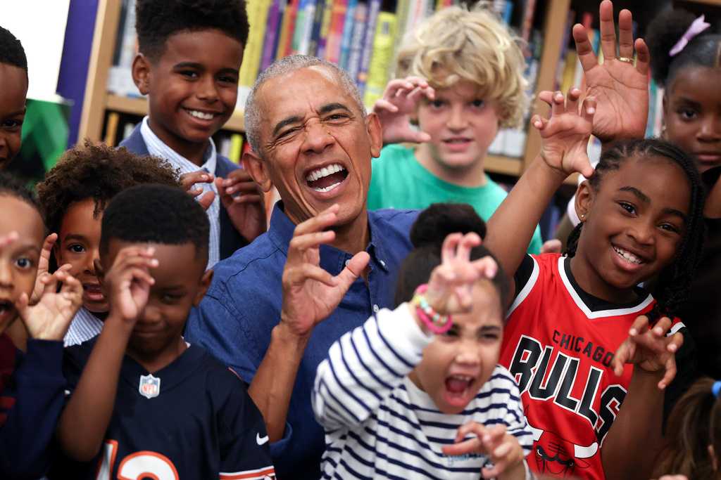 Barack and Michelle Obama surprise first visitors to newly opened presidential center