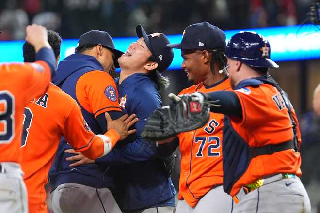 Houston Astros starting pitcher Tatsuya Imai, center, celebrates with teammates, including pitcher Alimber Santa (72) and catcher Christian V·zquez, right, after the team combined for a no-hitter against the Texas Rangers during a baseball game Monday, May 25, 2026, in Arlington, Texas.