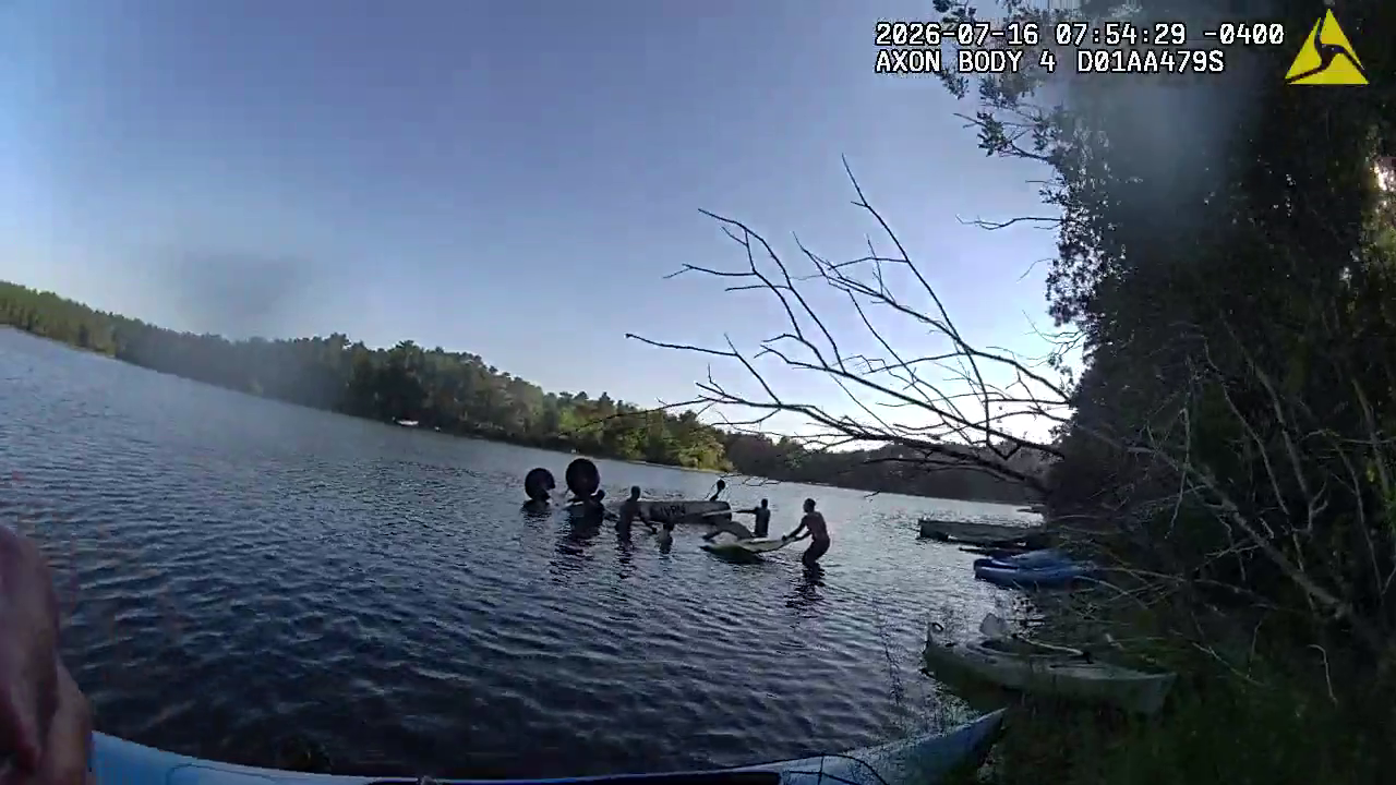 New video shows police officer race into pond to help free pilot